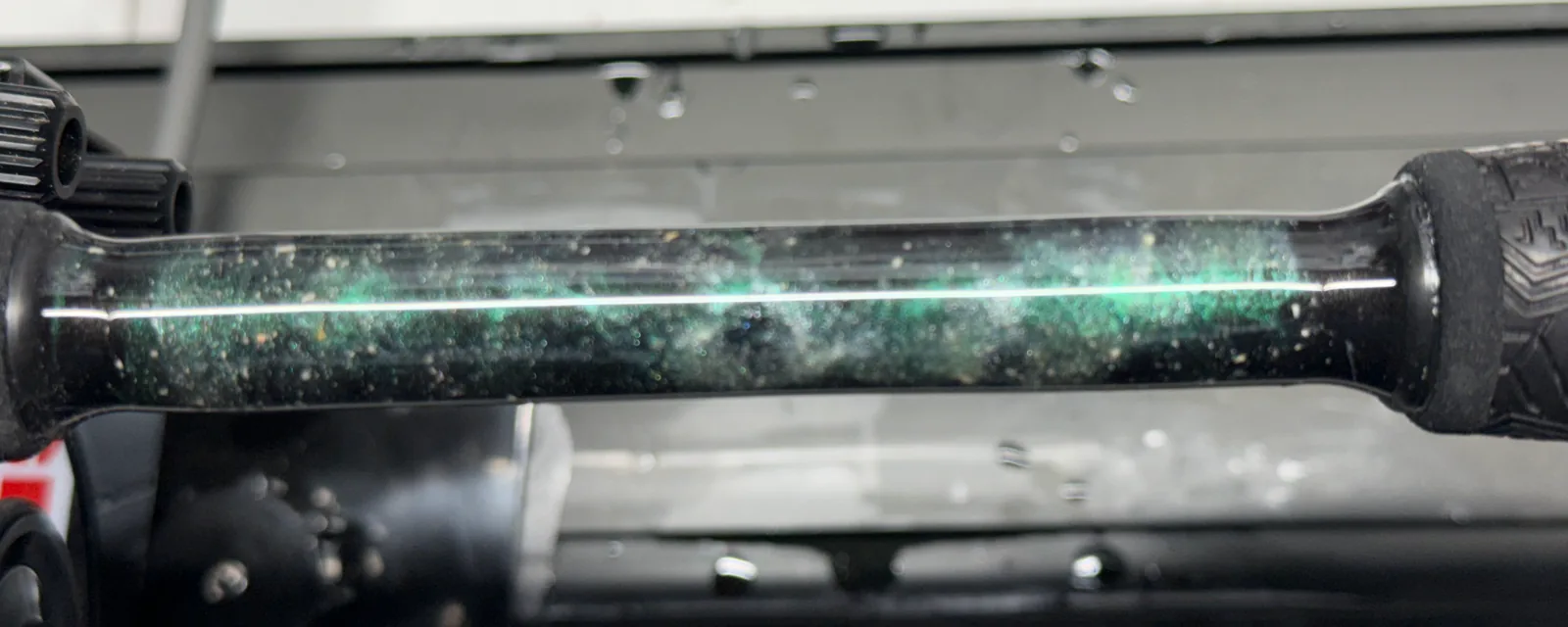 Close-up of the marbled split-grip section on Brian's father's rod, green and white swirls with his ashes set into the epoxy